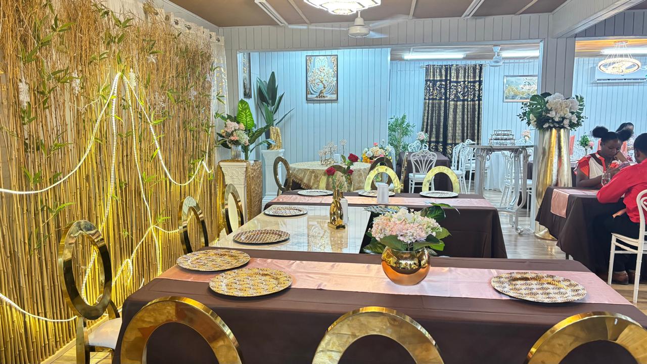 Restaurant interior with brown tablecloths and bamboo-style backdrop