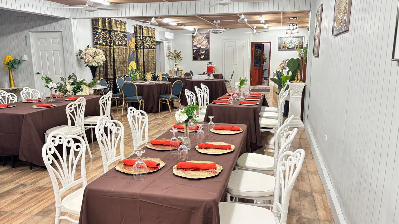 Red-napkin banquet setup with gold chargers in the main hall